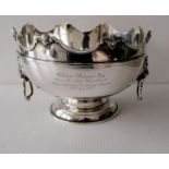A George V silver monteith with shaped rim, carved mask decoration, moulded girdle, flanked by
