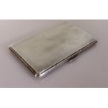 An Art Deco silver cigarette case with engine turned decoration, initialled to inside, hallmarked