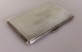 An Art Deco silver cigarette case with engine turned decoration, initialled to inside, hallmarked