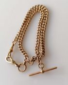 A late 19th century rose gold curb-link Albert chain with T-bar, stamped 9/375 to each link, maker's