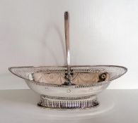 A George III silver pierced oval basket with fluted swing handle, beaded border, swag and festoon