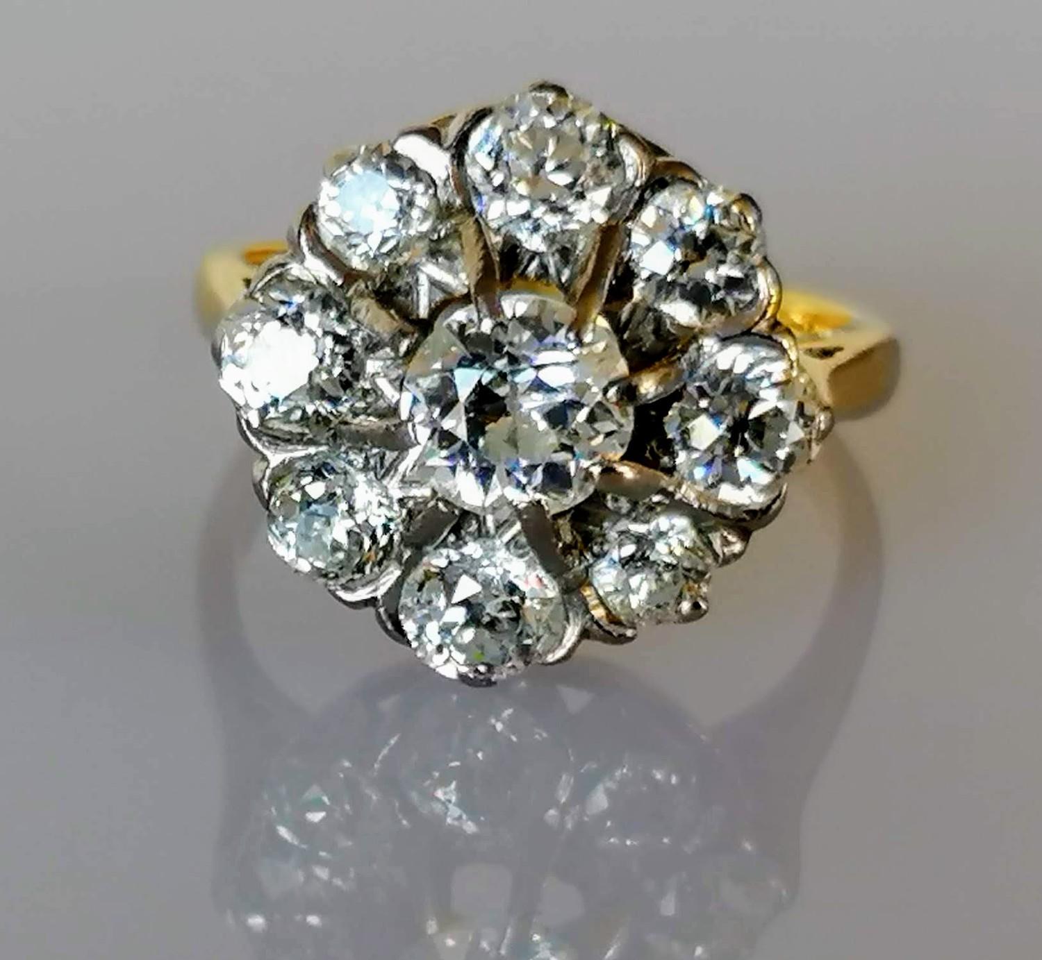 A diamond cluster ring on a claw-set yellow and white 18ct gold setting: the central old European- - Image 2 of 8