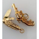 A 9ct gold pistol pendant or charm and penknife, both hallmarked, 38mm, 28mm, 12.6g