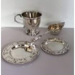 A George V silver christening mug on a stepped base, 7.5 cm H, marks rubbed; a tea strainer by