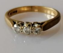 A vintage three-stone diamond ring comprising round brilliant-cut diamonds, estimated total 0.
