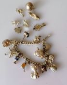 A silver charms bracelet, most with stamps/hallmarks, 79g