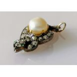 An Edwardian pearl and diamond pendant shaped as a serpent with peridot eyes, on white metal, 35 x