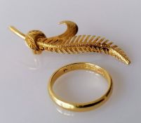 A yellow gold fern brooch with etched decoration, 50mm and a wedding band, size O, 3mm, both
