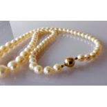 A mid-century single row of sixty-nine graduated Akoya cultured pearls measuring 6mm to 9.7mm with