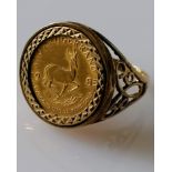 A 1/10th Krugerrand coin, 1985, on a pierced 9ct gold mount, size O, hallmarked, 6.09g