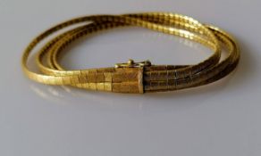 A four-stand textured gold bracelet with box clasp and safety clip, stamped 750, 27.8g