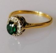 An emerald and diamond cluster ring on 18ct white and yellow gold, stamped, size K, 2.52g