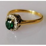 An emerald and diamond cluster ring on 18ct white and yellow gold, stamped, size K, 2.52g