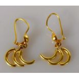 A pair of gold earrings with C-pipe design, unmarked, tests for high quality gold, 3.82g