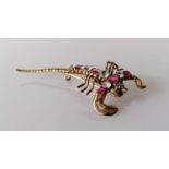 A ruby and diamond scorpion brooch on a gold base, 5.5 cm, unmarked, approximately 0.60 carats total