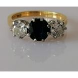 A three-stone sapphire and diamond ring on 18ct yellow gold and platinum, brilliant-cut sapphire