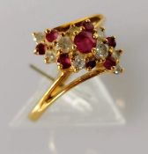 A ruby and diamond cluster ring on an 18ct gold setting, size P, stamped, 3.61g