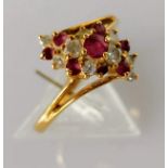 A ruby and diamond cluster ring on an 18ct gold setting, size P, stamped, 3.61g