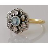 An Edwardian aquamarine and diamond flower ring on yellow gold, tests for 14ct, size Q, 4g