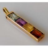 A four-stone baguette-cut multi-coloured channel-set stick pendant with loop in a yellow gold