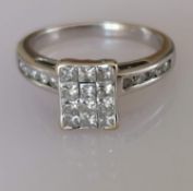 An 18ct white gold and diamond panel ring with twelve princess-cut diamonds and ten round