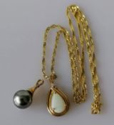 A teardrop-shape opal pendant on a yellow gold setting with matching chain, hallmarked 9ct, and a