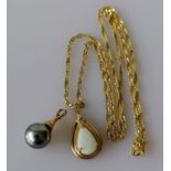 A teardrop-shape opal pendant on a yellow gold setting with matching chain, hallmarked 9ct, and a