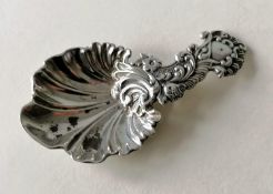 A Victorian silver caddy spoon with elaborate rococo decoration, scallop bowl by Martin, Hall & Co.,