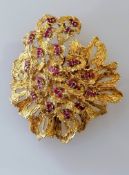 A mid-century pierced gold and ruby pendant/brooch with textured leaf-effect, hallmarked 18ct, 55