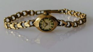 A mid-century 9ct gold-cased ladies dress watch by Regency with gold strap, hallmarked, not in