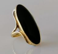 An elliptical onyx dress ring on a yellow gold setting, size M, stamped 9ct, 8.62g