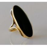 An elliptical onyx dress ring on a yellow gold setting, size M, stamped 9ct, 8.62g