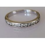 A diamond half-hoop eternity ring, the 18ct white gold band set with thirteen round brilliant-cut