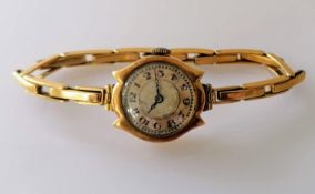 A mid-century ladies manual wristwatch with Arabic numerals, Swiss mechanism, gold case and