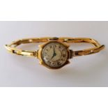 A mid-century ladies manual wristwatch with Arabic numerals, Swiss mechanism, gold case and