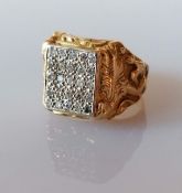 A larger yellow gold signet ring with a panel of twenty-five round-cut diamonds, each