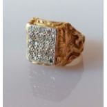 A larger yellow gold signet ring with a panel of twenty-five round-cut diamonds, each