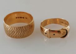 A yellow gold textured band, 10mm, and a buckle ring, both size T and hallmarked 9ct, 9.54g