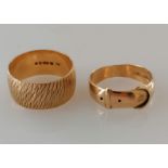 A yellow gold textured band, 10mm, and a buckle ring, both size T and hallmarked 9ct, 9.54g