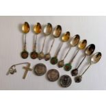 A selection of silver presentation teaspoons, three silver medals, a silver bangle and a crucifix