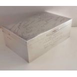 A larger Birmingham silver cigarette box of oblong form with presentation signatures and dedication,