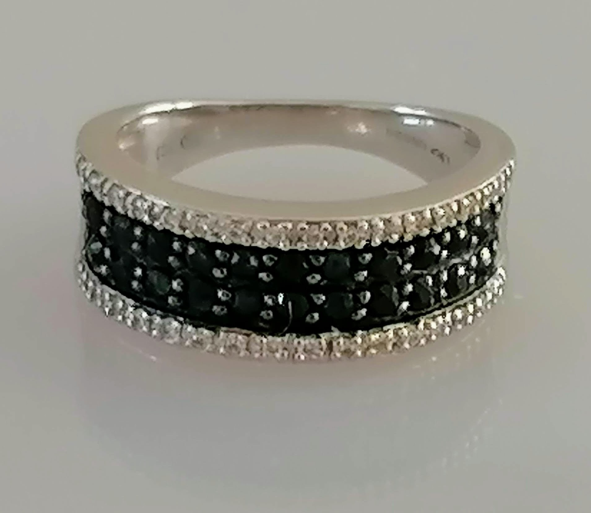 An 18ct white gold half-hoop eternity ring with pave-set white and black diamonds, size N1/2, - Image 4 of 4