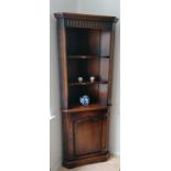 A Royal Oak Furniture Company Balmoral range corner unit with arcaded carved design, shelved