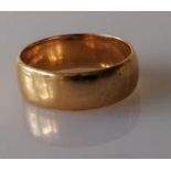 A yellow gold wedding band, 6mm, unmarked, tests for 18ct, size P, 6.27g