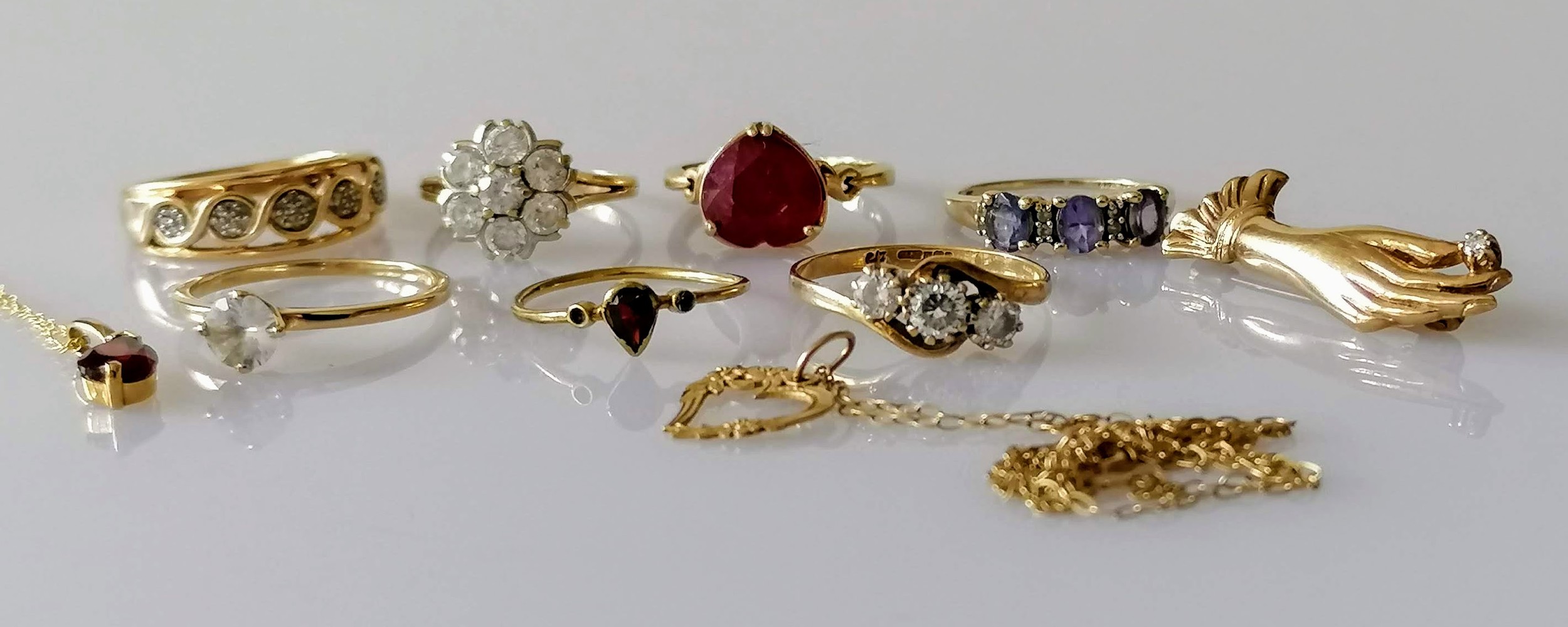 Seven gold gem-set rings, mixed sizes, one brooch and two pendants, all hallmarked 9ct, 19.32g (10)