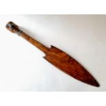 A wooden tribal spearhead with sculpted terminal, 46 cm