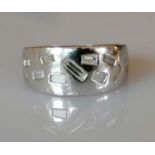 A mid-century platinum and diamond ring with tapering shank, irregular baguette diamonds, size O,