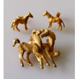 A gold brooch depicting two prancing horses, unmarked, tests for 14ct, 35 x 40mm, 11.47g and a