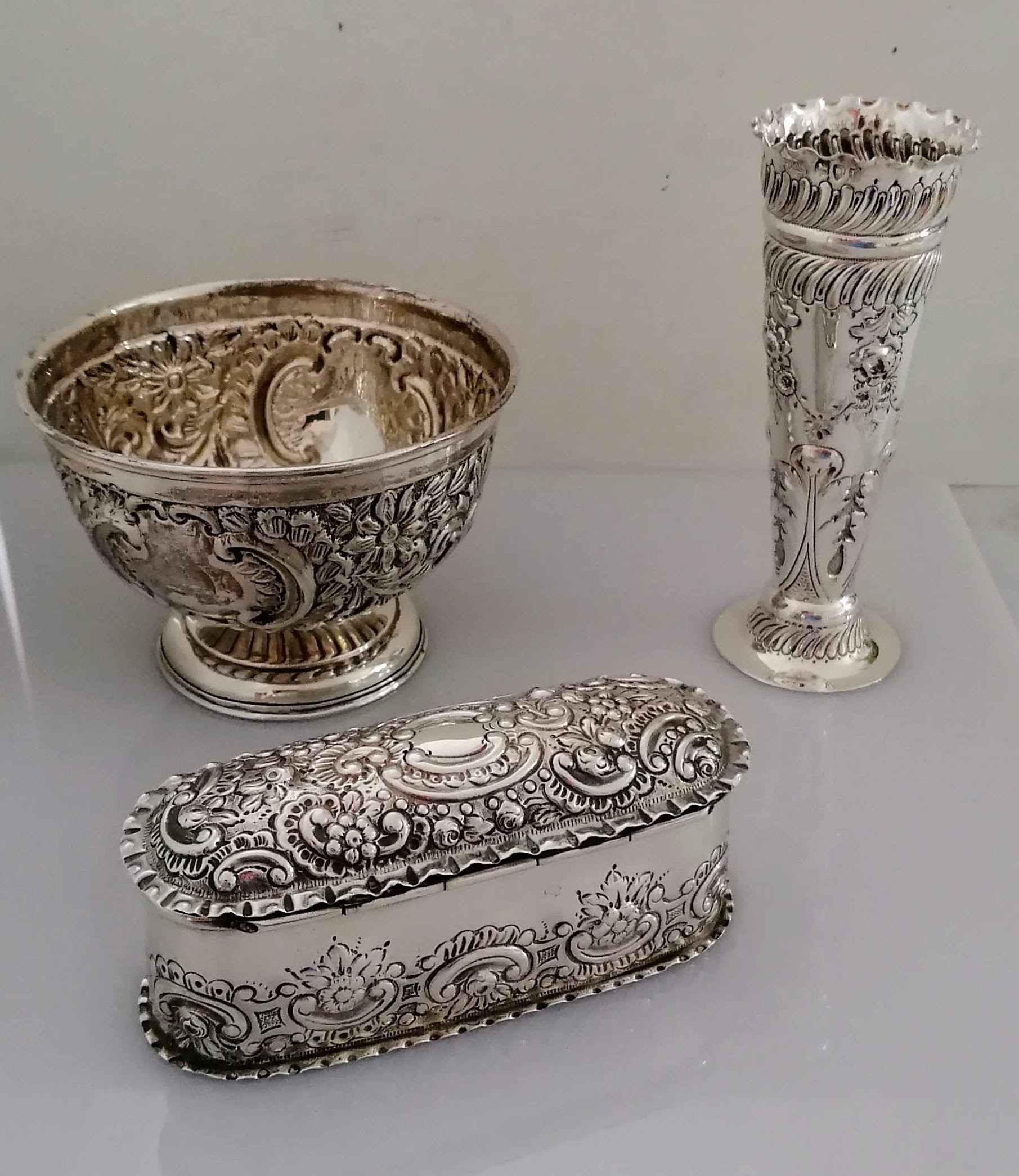 A Victorian silver oblong box with hinged cover with elaborate embossed rococo decoration by Charles