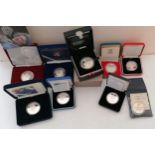 An assortment of cased silver crowns relating to QE2 to include: 1977 Silver Jubilee; 60th